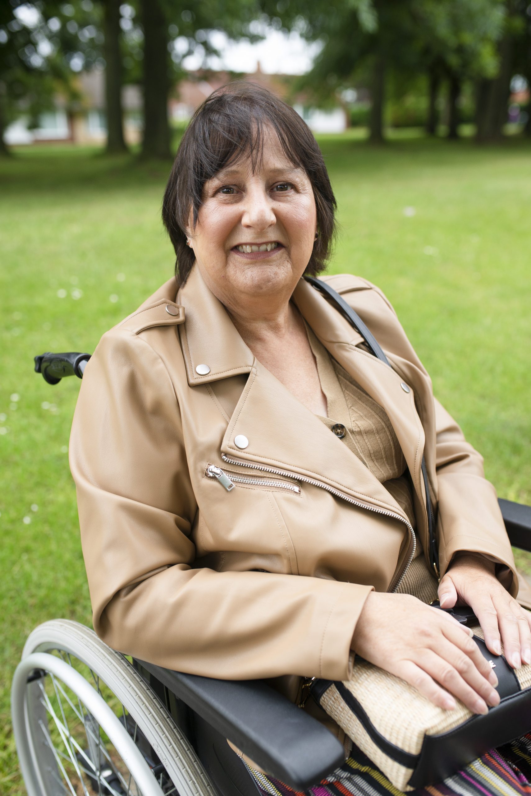 Image of Janet Rebair in a wheelchair, osteosarcoma patient