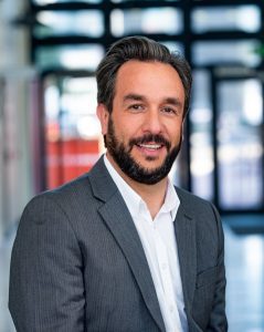 Photo of Man in suit smiling at camera