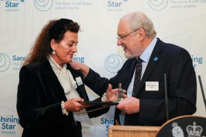 Gina Long receives award from Roger Wilson.