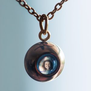 Photo of stanhope necklace with an image of a woman inside.