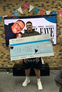 Marshall Exler holding a cheque