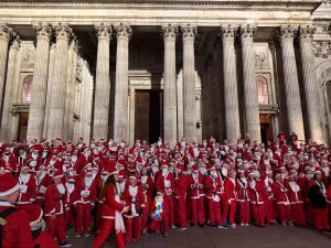 Santa in the City 2024 runners gather in front of St Paul's Cathedral