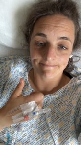 Catriona Fraser Harris giving a thumbs-up in hospital bed