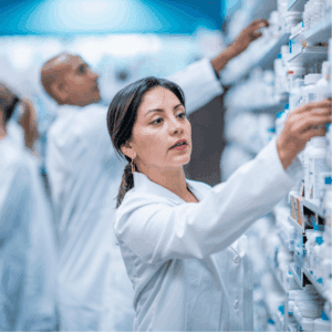 Pharmacist taking medication from shelf