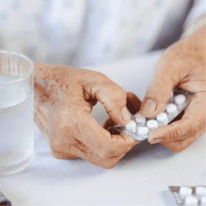 Hands taking medication