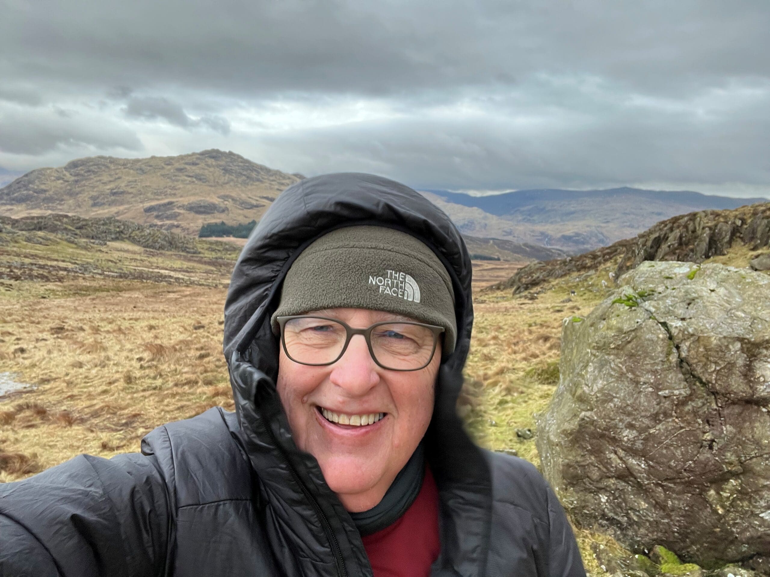 Mike in winter gear standing on a mountain top